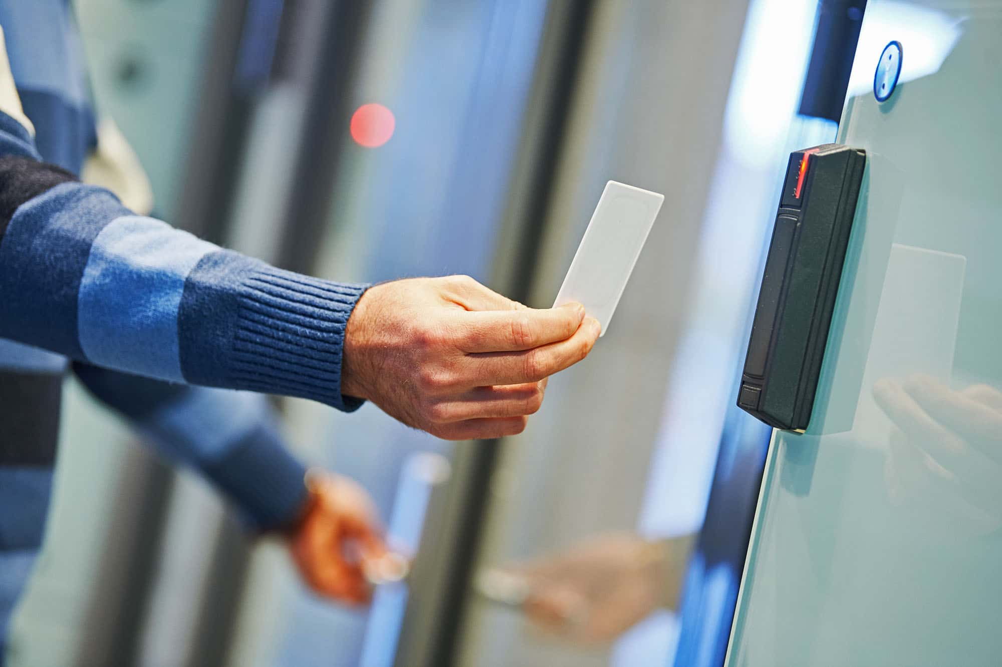 Business man using access control systems swipe card